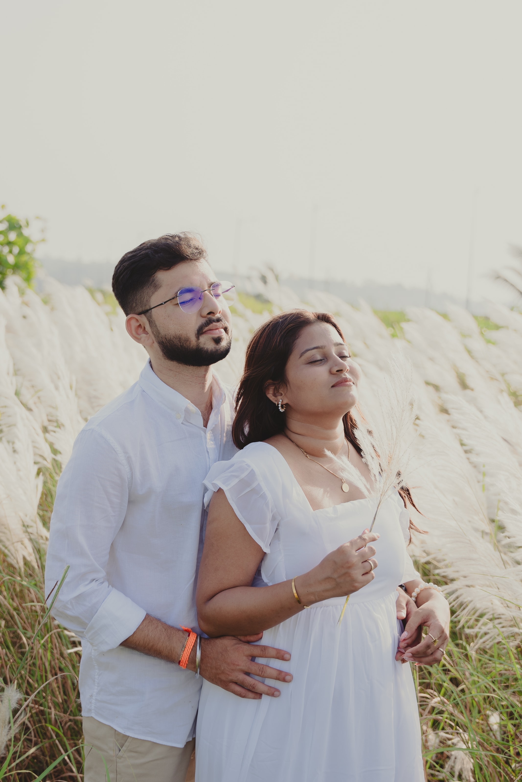 A couple in white among tall pampas grass, photograph 02
