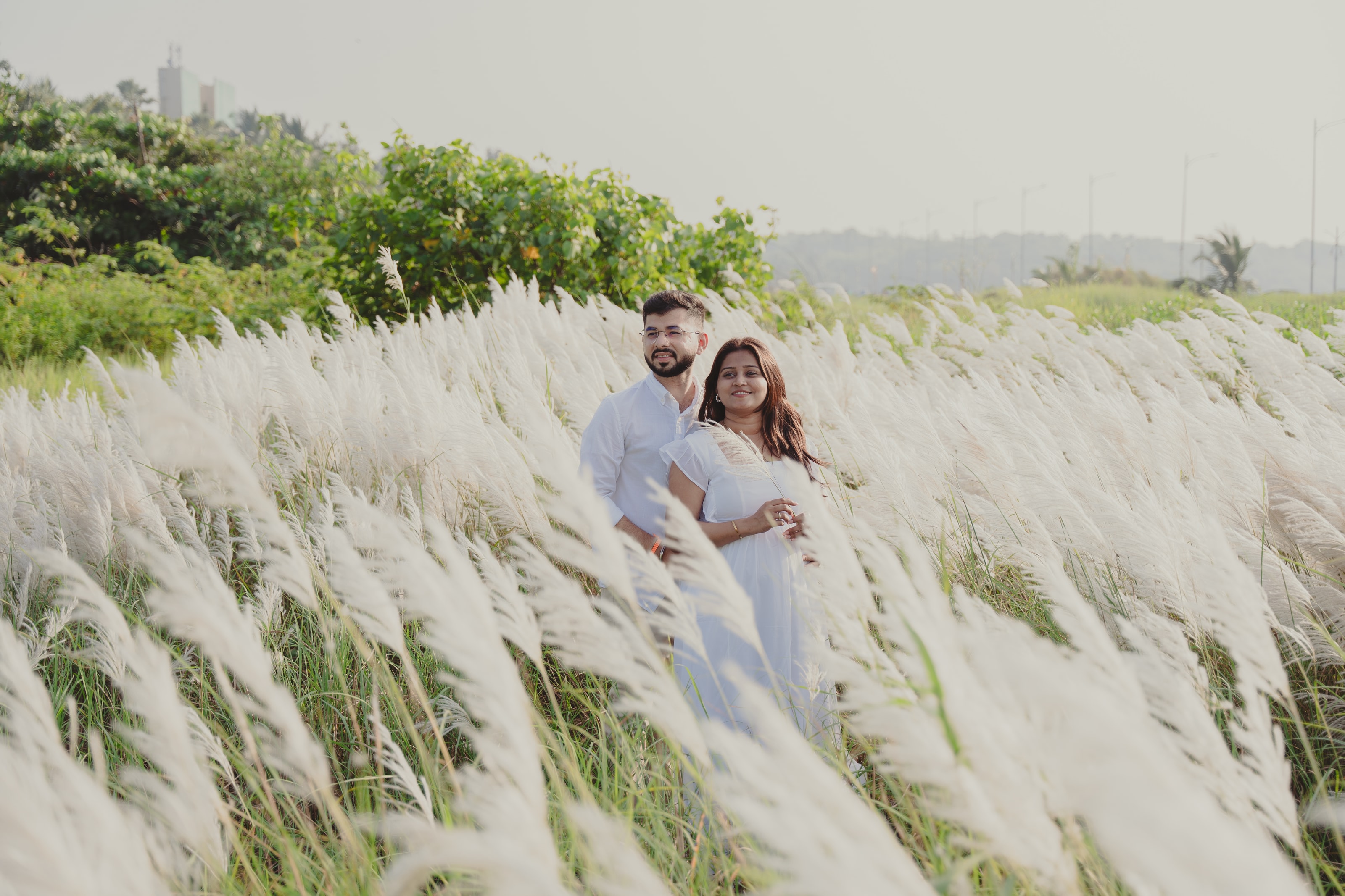 A couple in white among tall pampas grass, photograph 03